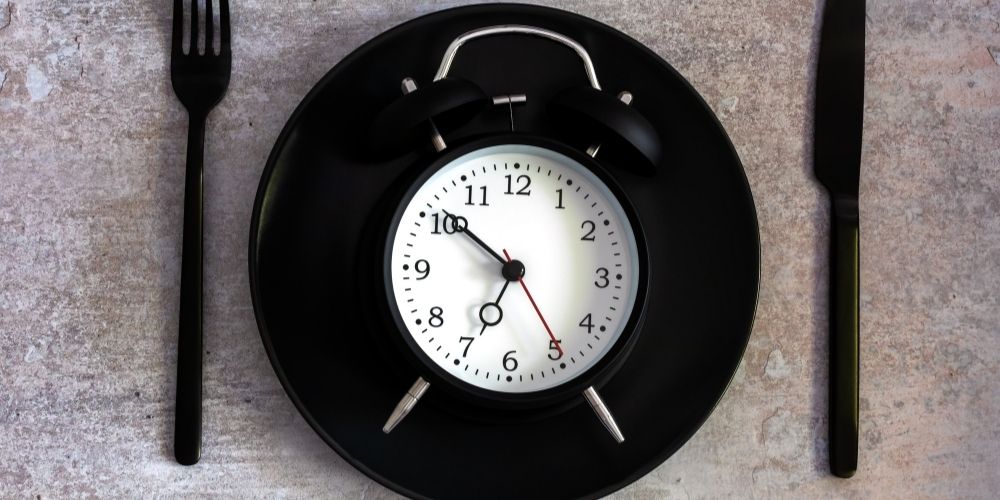 A plate with a clock on it instead of food.