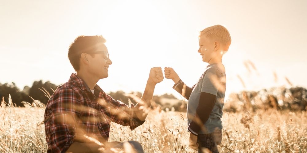 Dad and son having fun in a grain field.