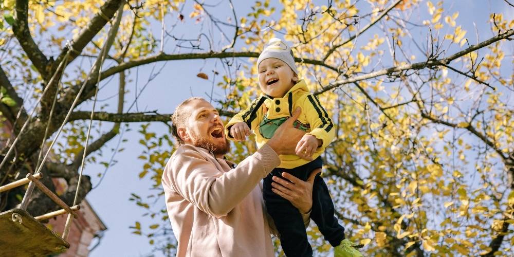 Man outside playing with his son.