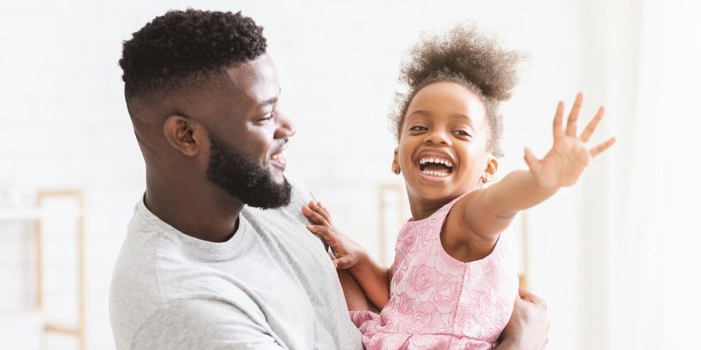 A happy dad with his smiling daughter.
