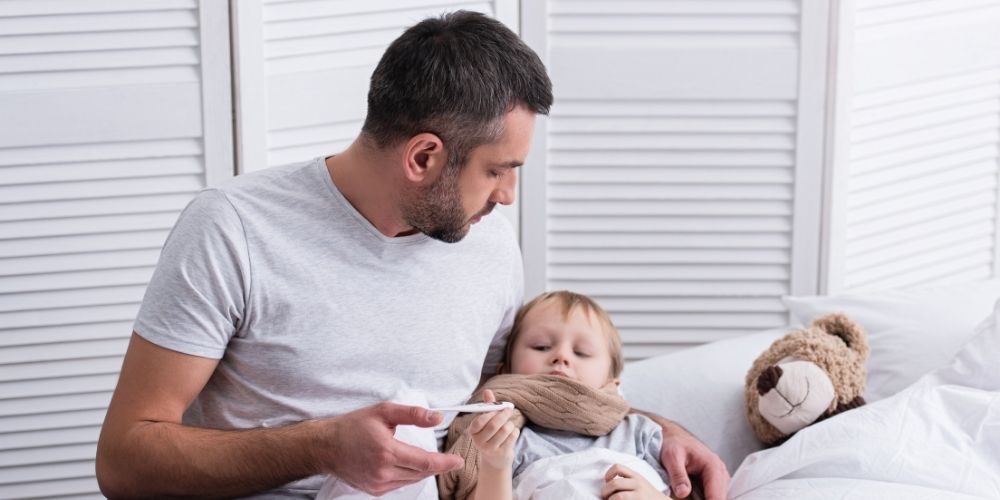 Dad taking care of his sick son.