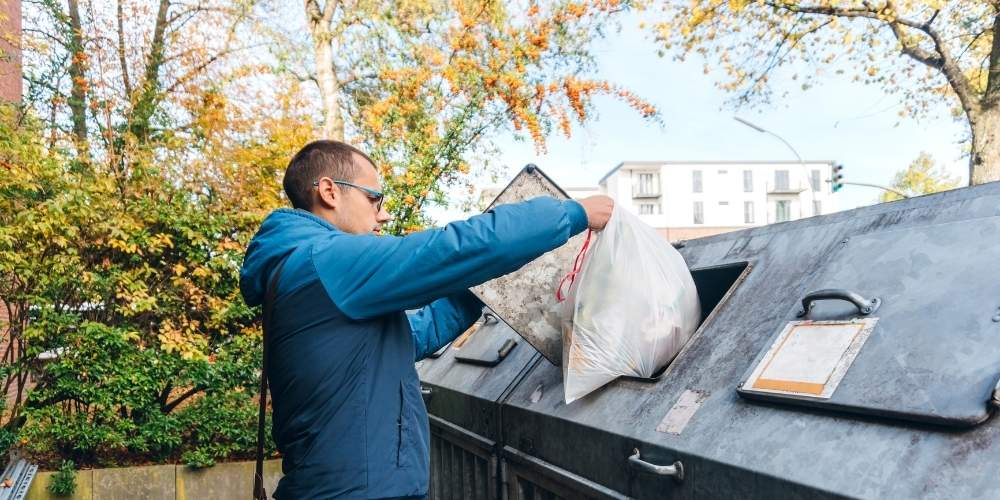 A man taking out the trash.