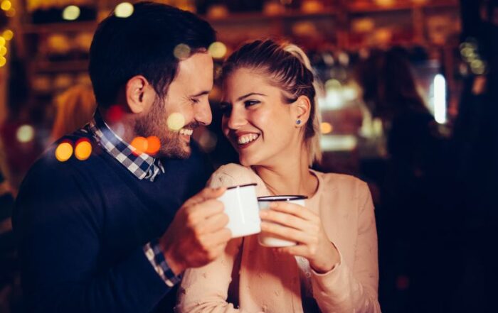 A couple on a date, smiling at each other.