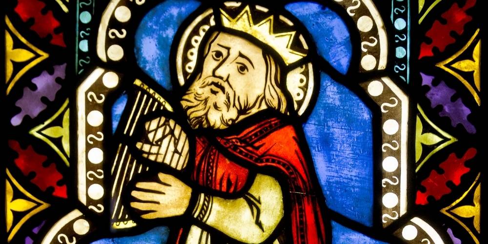 Stained glass art of King David with his lyre.