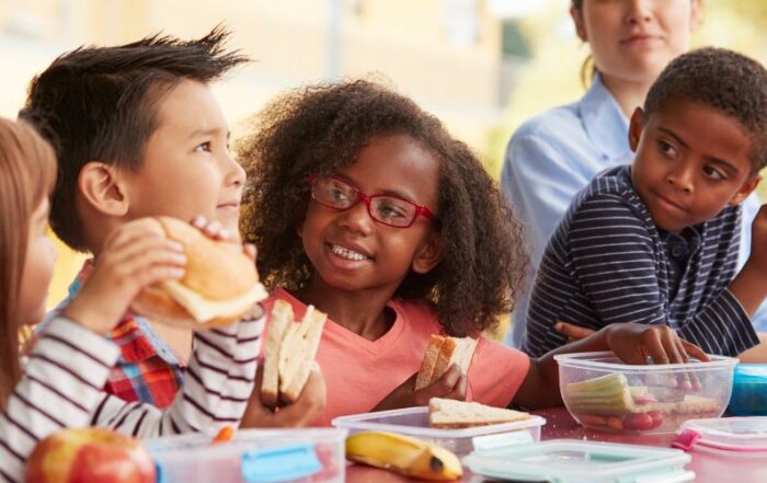 Happy children eating lunch together.