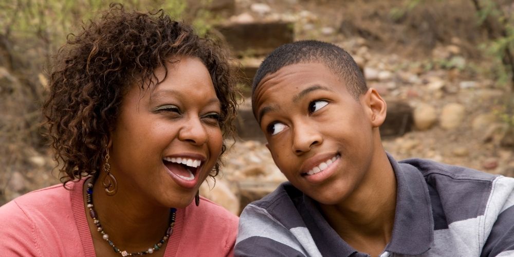 Mom sitting with her son outside, enjoying her time with him.